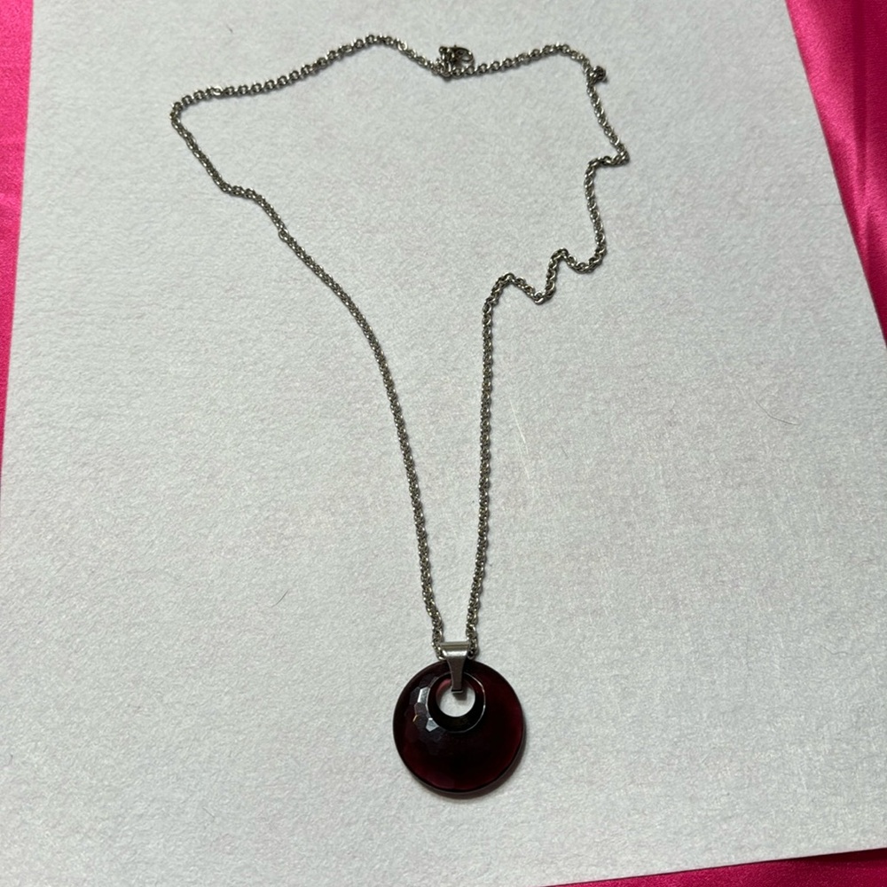 Silver colored chain with purple translucent glass.